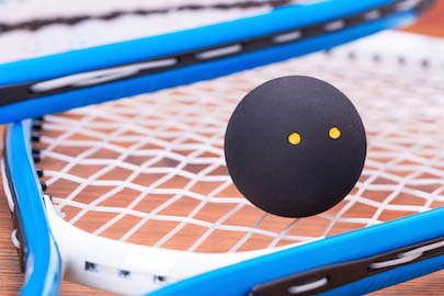 close up of squash ball on racket