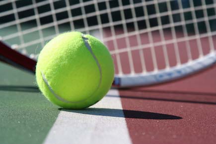 tennis ball in front of racket